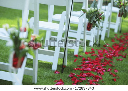 A Path Of Rose Petals Behind A Row Of White Chairs; Troutdale, Oregon, United States of America