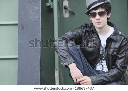 A Teenage Boy Sitting On The Back Of A Train; Portland, Oregon, United States Of America