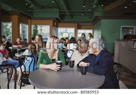 People Chatting In Cafe