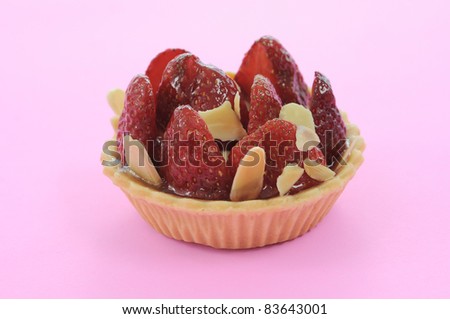 Strawberry cupcake on pink background.