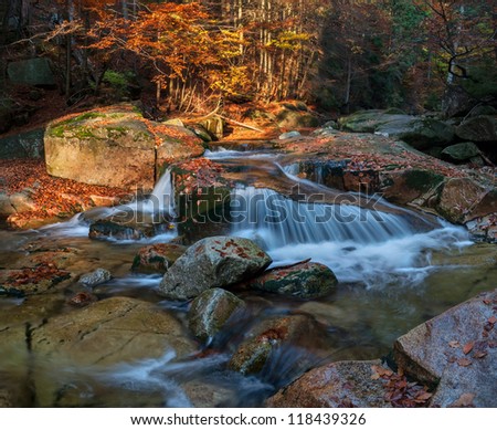 Panoramic view of a beautiful autumn waterfall.