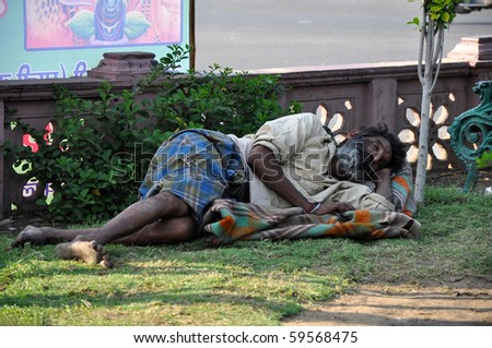 JAIPUR, INDIA - NOVEMBER 4: An unidentified indian homeless man sleeps in the public park in Jaipur on November 4, 2009. Homeless people represent serious social problem through the whole India.