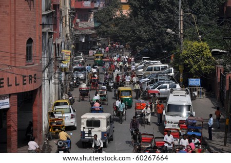 OLD DELHI, INDIA -OCTOBER 24: Traffic jam with rickshaws, motorbikes, cars and pedestrians on local city street on October 24, 2009 in Old Delhi. Traffic jam is the main problem of transportation in Delhi.