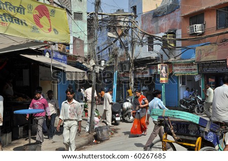 OLD DELHI, INDIA -OCTOBER 24:People travel under the risky and chaotic electrical wiring on October 24, 2009 in Old Delhi. Unsatisfying condition of wiring causes power problems in Delhi.