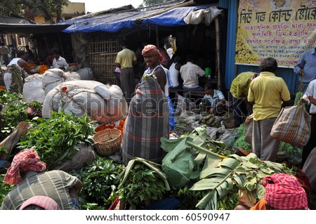 KOLKATA, INDIA - 27 OCTOBER: An unidentified group of people buy and sell flowers on flower market in Kolkata on October 27, 2009.  The Kolkata flower market is the largest one in eastern India.