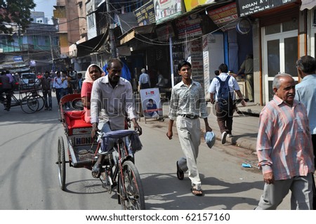 DELHI, INDIA - OCT 24: An unidentified indian woman travels by rickshaw in Delhi on October 24, 2009. Rickshaw men are one of the hardest working people and also poorest in the whole India.