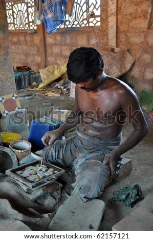 MADURAI, INDIA - NOV 7: An unidentified man works hard in tile factory on November 7, 2009 in Madurai. This type of factories is typical for the region of Madurai on the south of India.