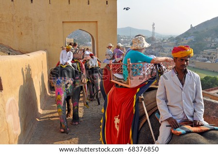 AMBER, INDIA - NOV 4: Indian elephant riders ride with tourists to Amber Fort on November 4, 2009 in Amber. On the ride, one can see the skyline of Jaipur, Maotha lake, and the original city walls.