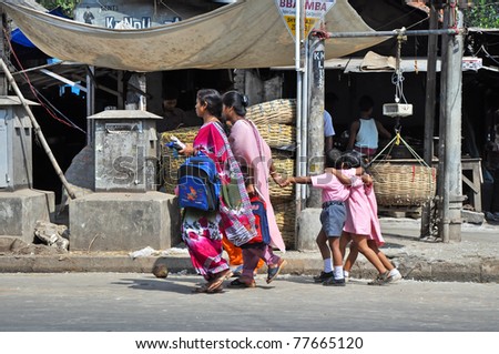 NEW DELHI, INDIA - OCTOBER 27: Indian mothers accompany their children from school in New Delhi on October 27, 2009. Education has been made free for children for 6 to 14 years of age in India.