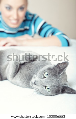Cat laying and smiling lady on a background
