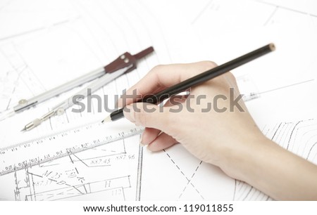 Hand of engineer working on a construction plan