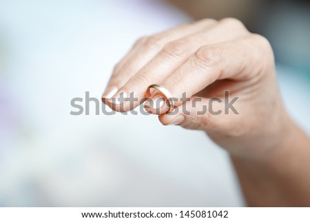 Hand of senior woman holding engagement ring