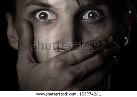 Afraid man covering his mouth by the hand