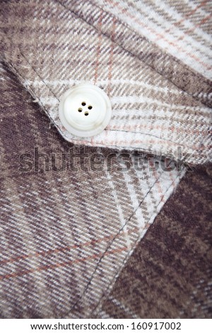Pocket with button of the frieze shirt. Close-up photo