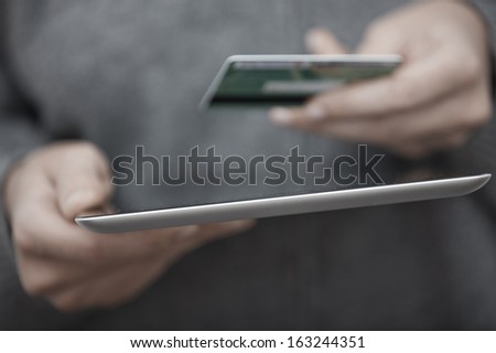 Human hands with tablet PC and credit card