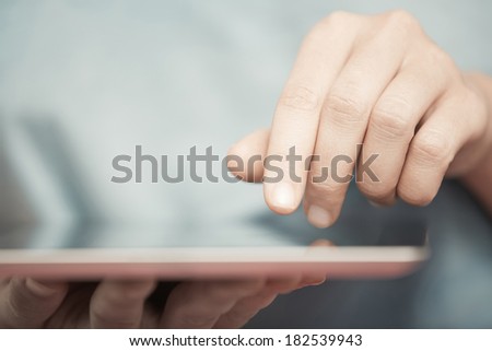 Human hands working with digital tablet