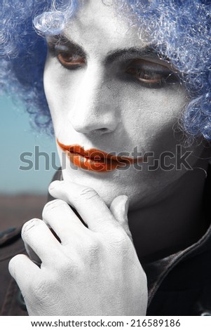 Pensive clown with blue wig. Vertical colorful portrait