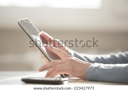 Hands of woman working with digital tablet