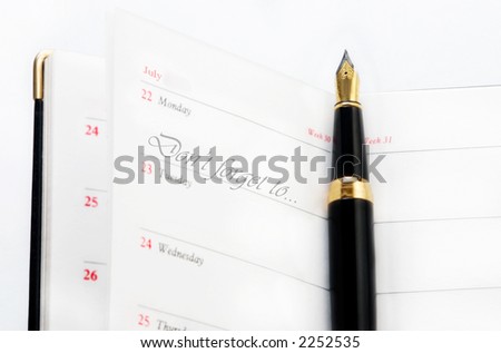 photo of note book with golden pen and mark
