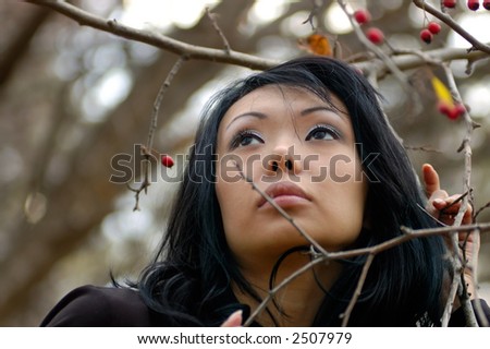 Photo of beautiful sad woman in the autumn berry-field