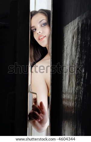 stock photo Photo of the pretty woman opening door and keeking