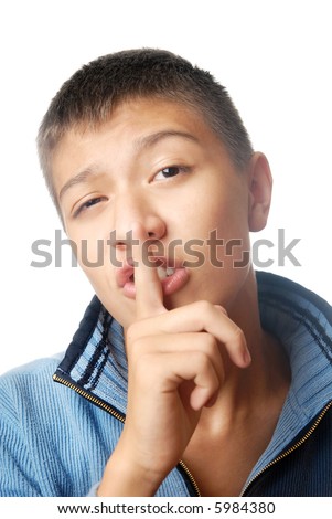 Boy with finger at the lips as a symbol of secret