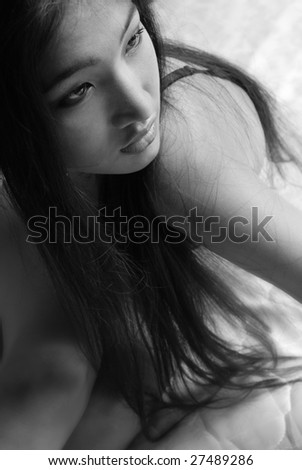 Black and white photo of the sad lady sitting indoors