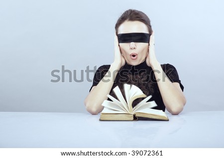 Turned book and screaming lady with closed ears and blindfold
