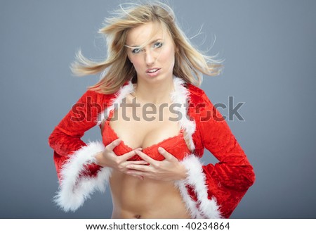 Very sexy young woman in revealing Santa costume and red lace underwear