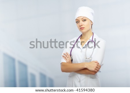 Cross-armed doctor with stethoscope in clinic. Healthcare theme