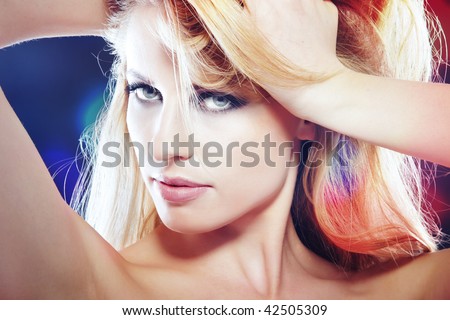 Sexy lady in the disco nightclub with spotlight illuminated on her skin. Horizontal photo with vibrant color