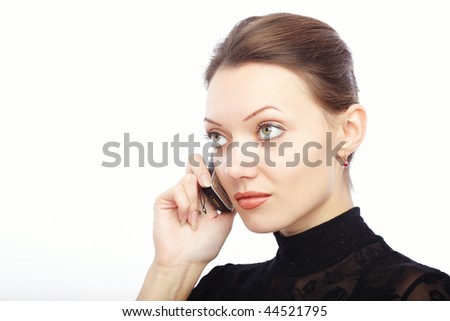 Serious lady on a white background talking via cellphone