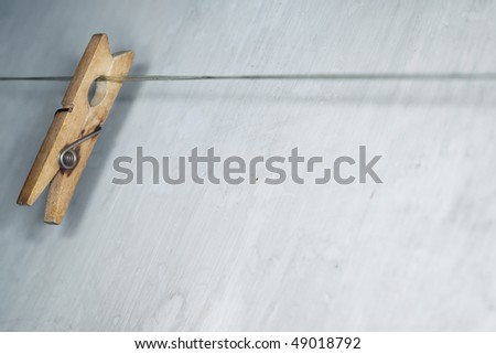 Close-up horizontal photo of the old wooden clothes pin hanged on a clothes-line