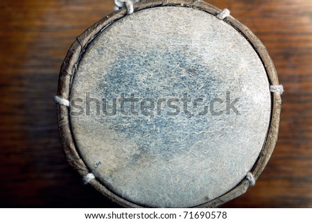 Old leather drum. Top view on the surface. Horizontal photo with shallow depth of field