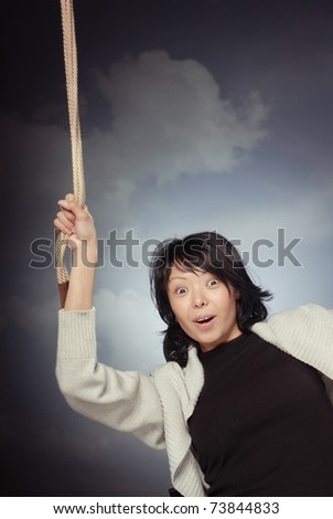 Funny lady falling and holding the rope on a sky background