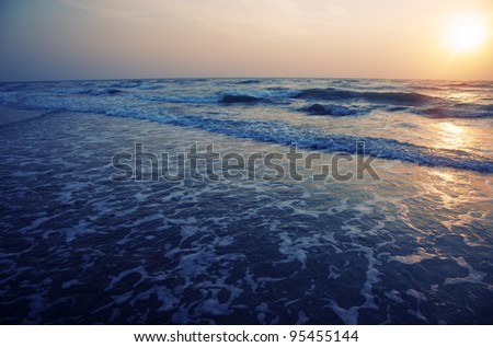Horizontal photo of the sea during sunset. Natural darkness and colors