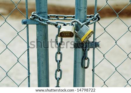 Chain link fence locked with pad locks.