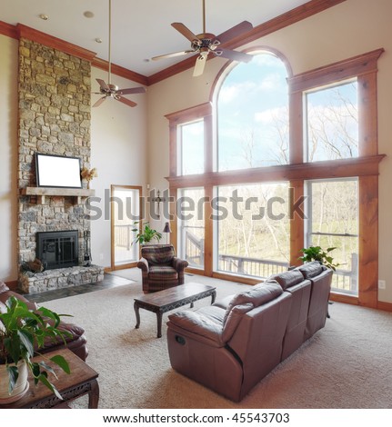 Traditional living room interior with a high ceiling and large windows. Square format.