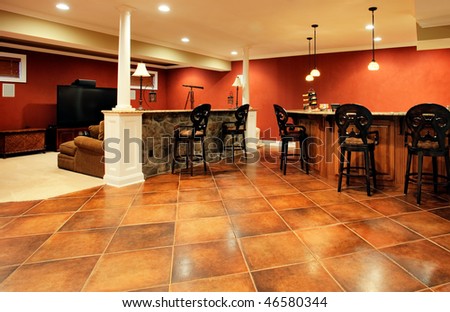 View of family room with bar, home theater area, and parquet floor. Horizontal format.