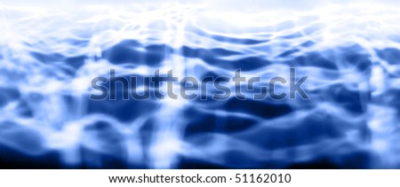 Light reflecting off the ripples on a water's surface. Horizontal shot.