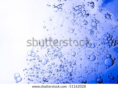 Underwater shot looking up towards the water\'s surface as air bubbles rise to the top. Horizontal shot.