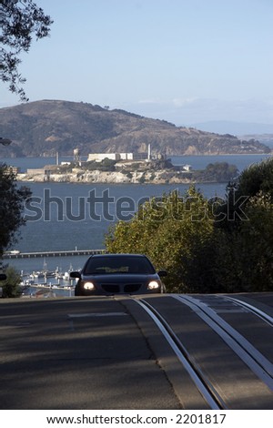 Road Network in San Francisco with Alcatraz and San Francisco Bay in background and car in front