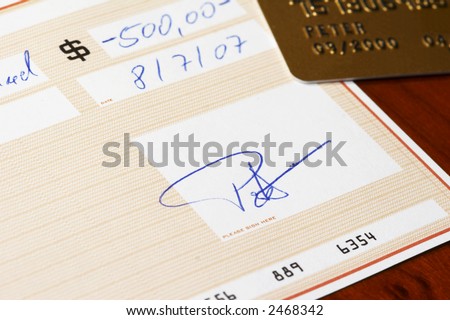 bank check, gold credit card in background