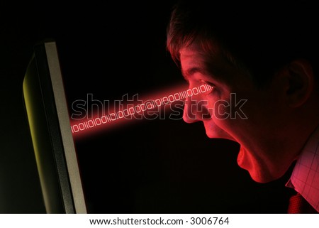 A man in shirt and tie screams at a red computer monitor data streams into his eyes