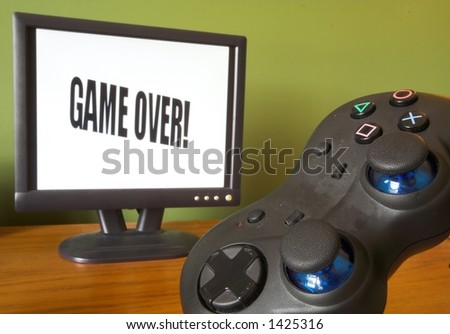 game controller and screen showing game over