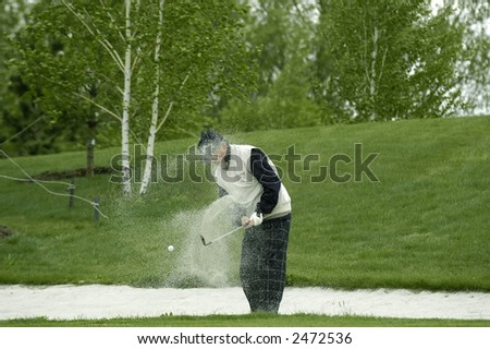 a golfer beats out a ball