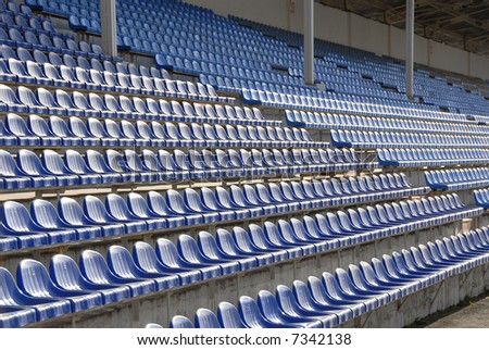 empty arm-chairs on a stadium