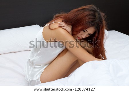 lonely woman on bed with accumulated stress, worry, loneliness, mental problem or sickness