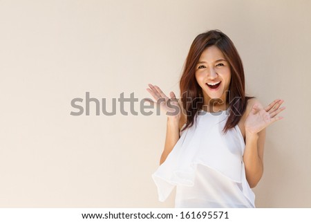 happy woman showing exciting positive expression with blank background, warm tone brown beige color