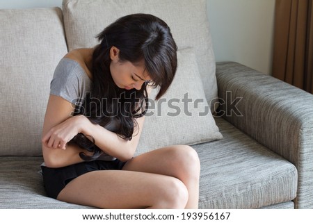 menstruation pain, stomach ache, digestive problem of woman in indoor scene